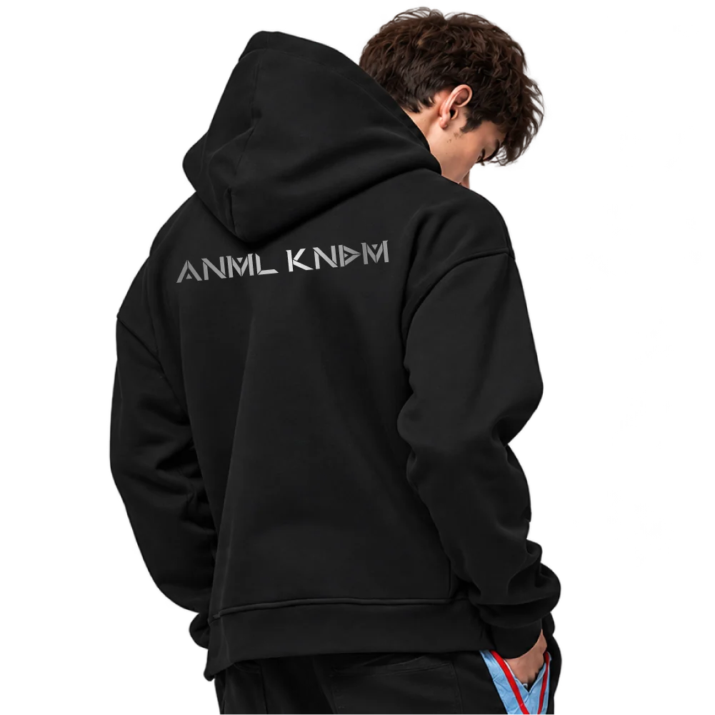 The back of the black hoodie with the ANML KNDM wordmark across the shoulders